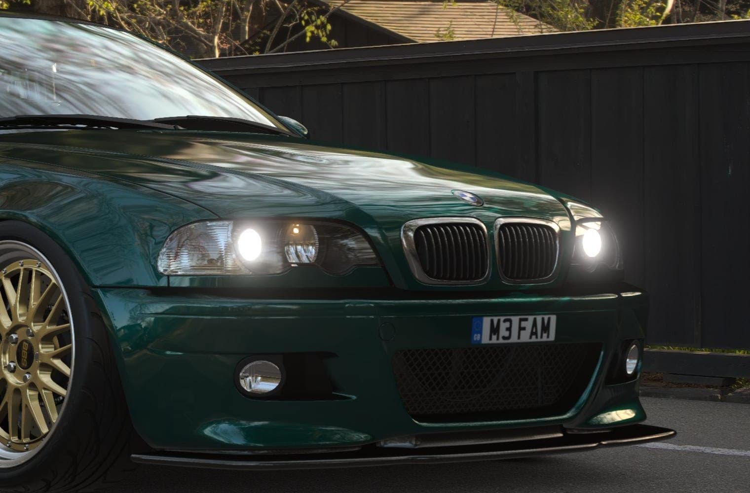 The front of a BMW E46 M3, headlights on